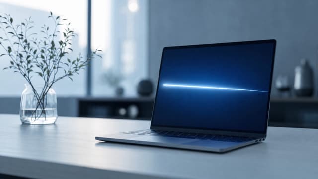 A laptop on a desk with a clean blue screen.